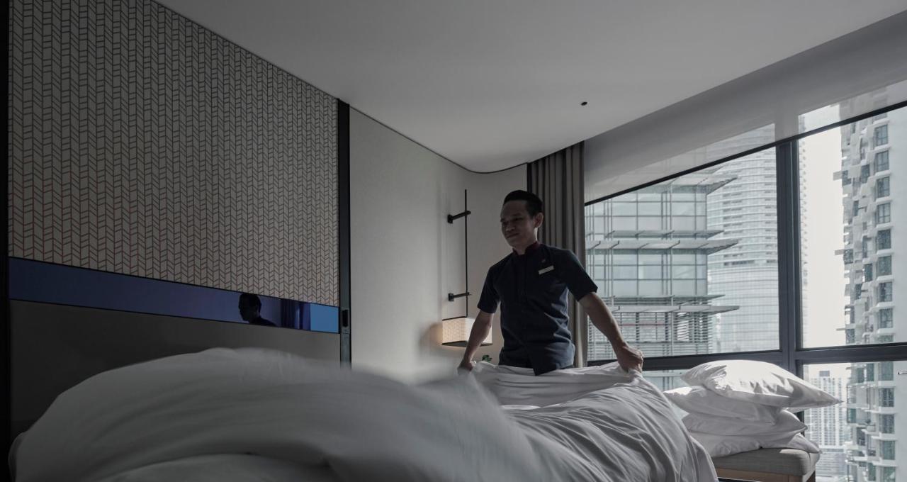 Amari Kuala Lumpur Otel Dış mekan fotoğraf A hotel housekeeper making a bed